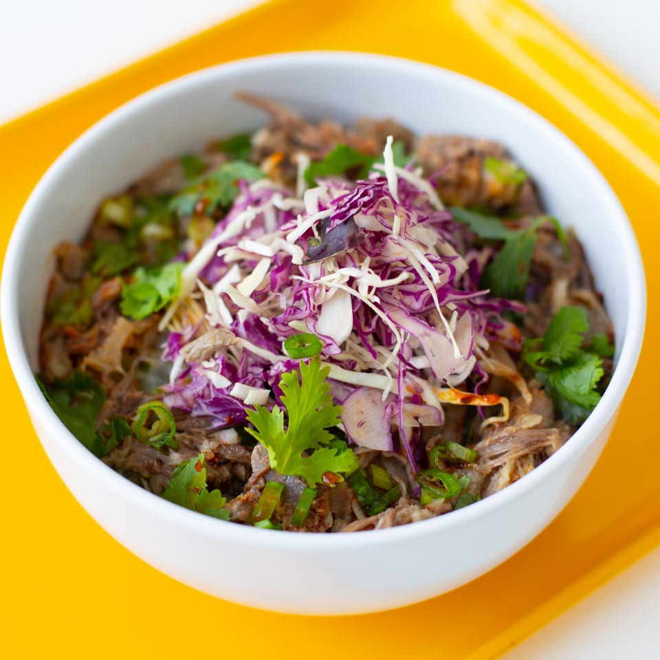 GoPho's Vietnamese bowl with shredded meat, cilantro, green onions, and purple and white cabbage.